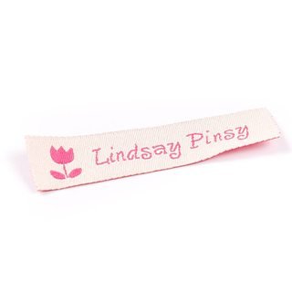 Woven label sample with the name "Lindsay Pinsy and a tulip in pink on white